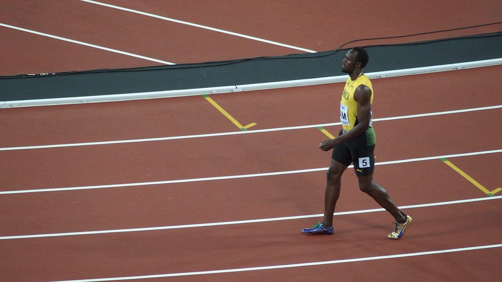 Usain Bolt running in a sprint final