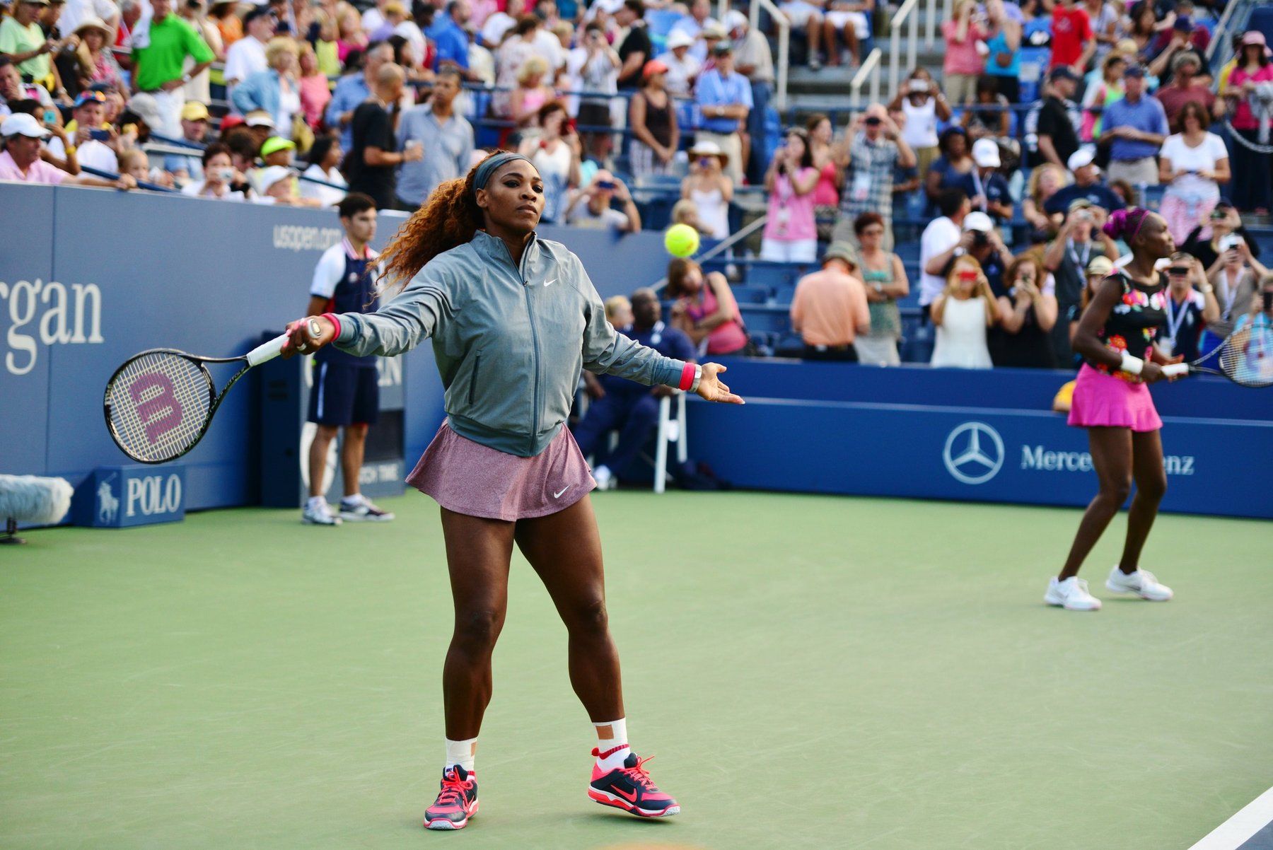 Serena and Venus Williams on court together during a doubles match